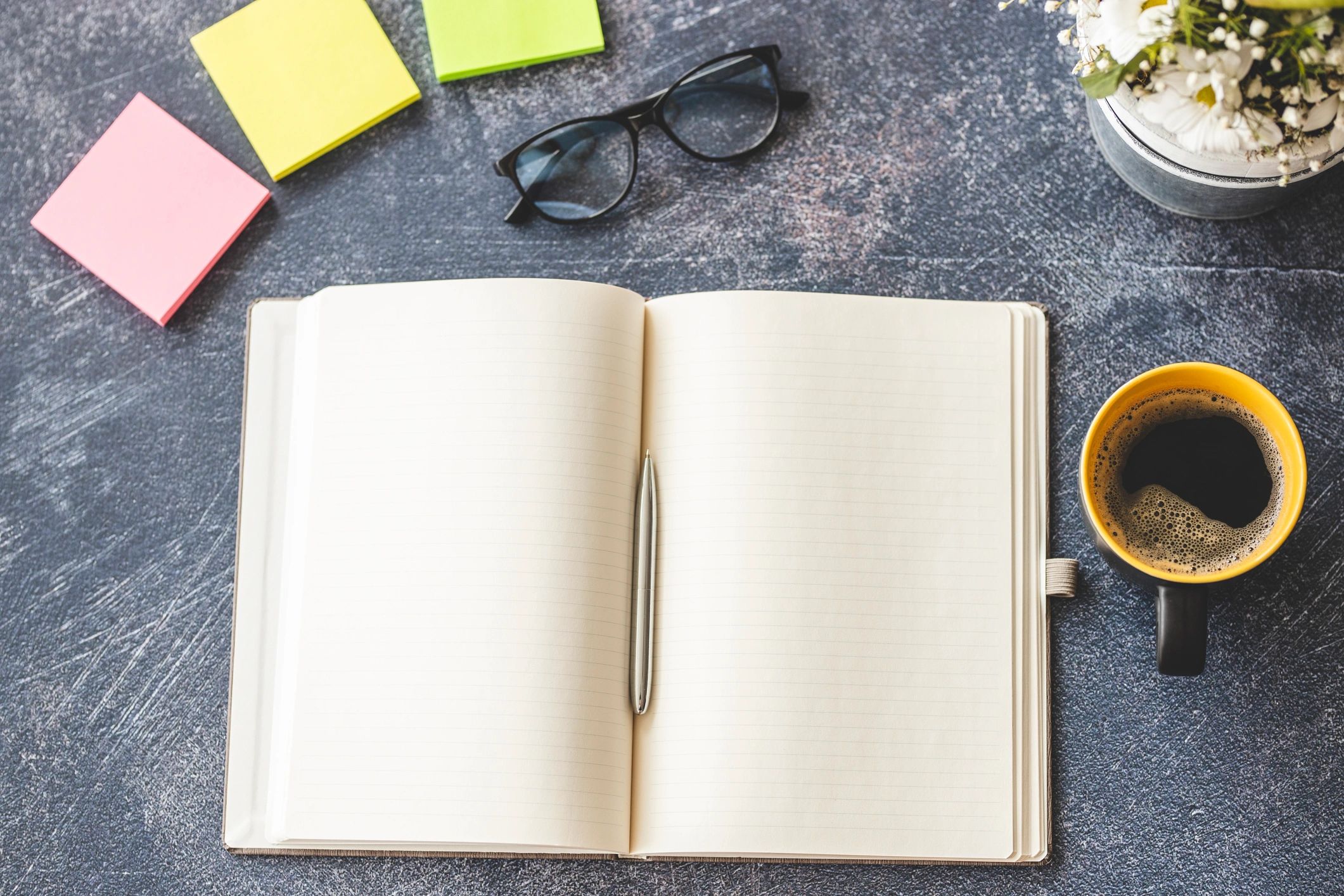 Notebook and coffee on a modern desk