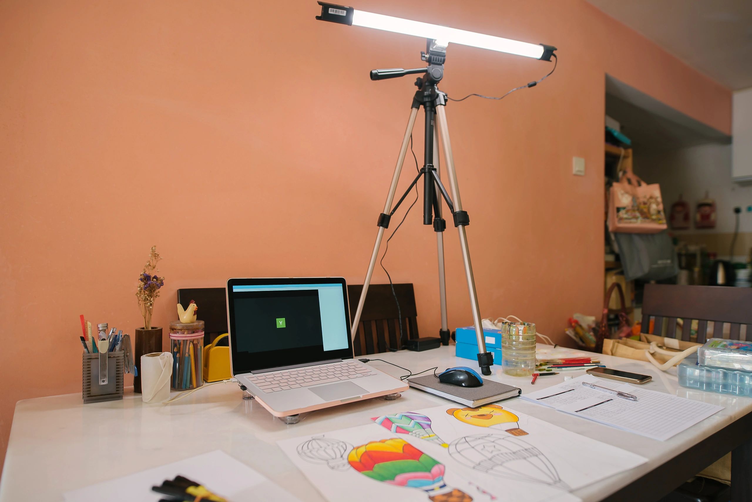 Laptop on a desk set up for an online session.