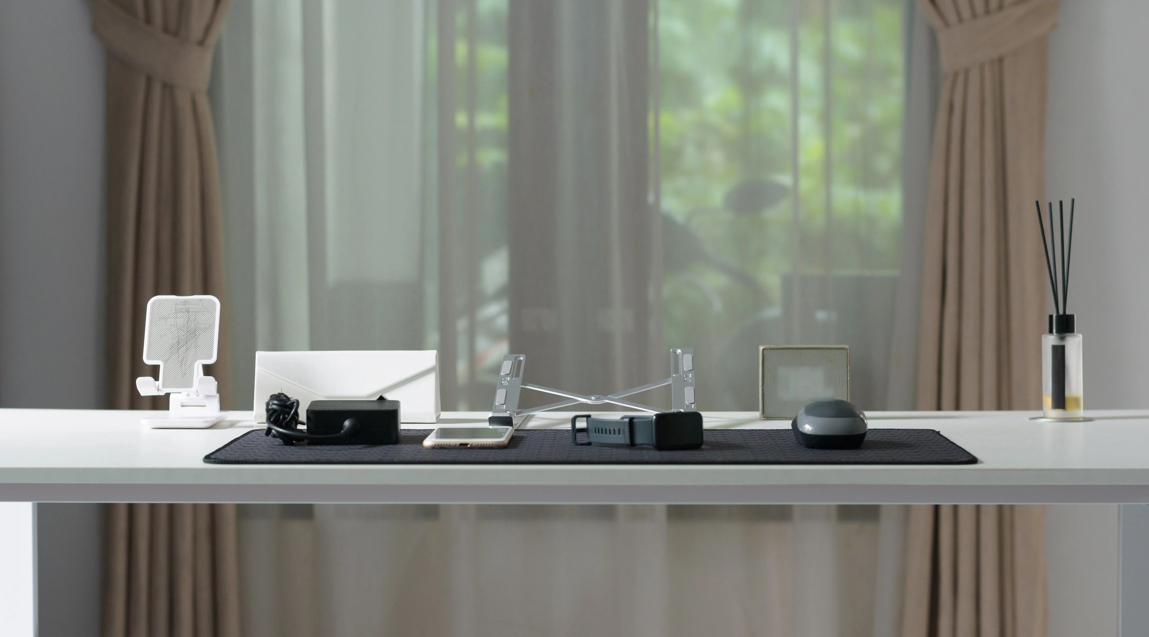 Minimalist desk setup against a window