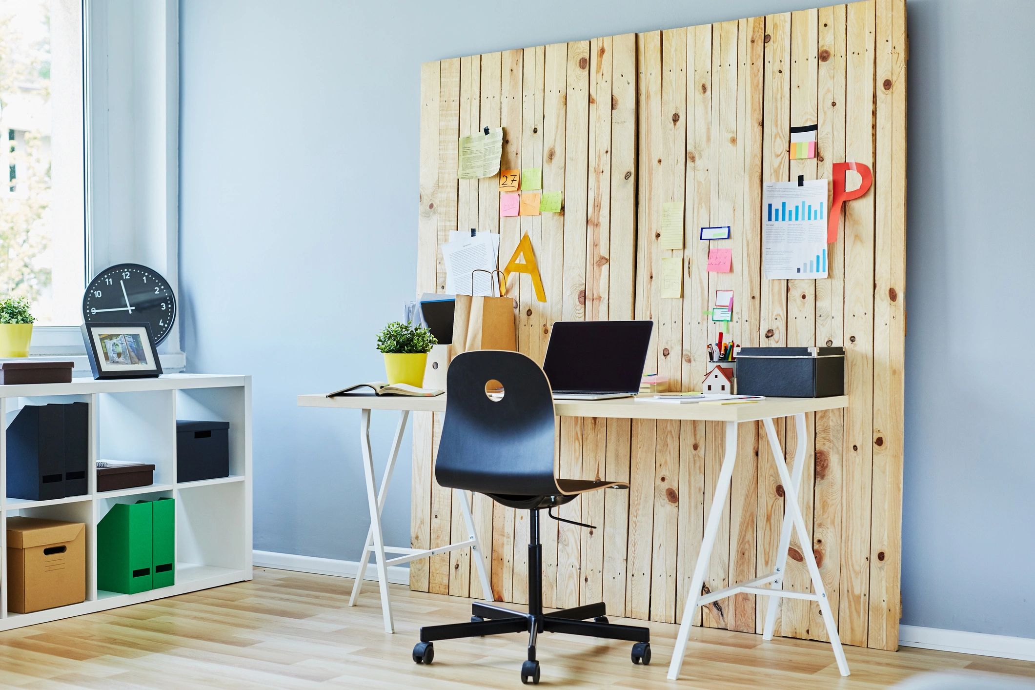 Modern workplace with wooden wall